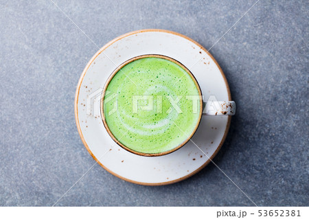 Matcha, green tea latte in a cup. Grey stone background. Top view. 53652381