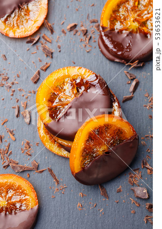 Candied orange slices in chocolate. Slate background. Top view. 53653621