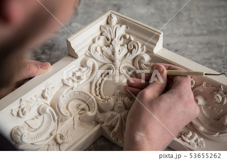 The sculptor creates a bas-relief. Plaster workshop. Close up. Selective focus. The sculptor creates a bas-relief. Plaster workshop. Close up. Selective focus. 53655262