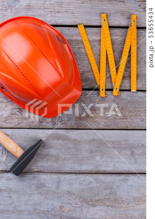 Hammer, hardhat and folding ruler. Hammer, hardhat and folding ruler. 53655434