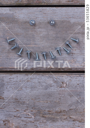 Composition with screws nails on wooden background. 53655829