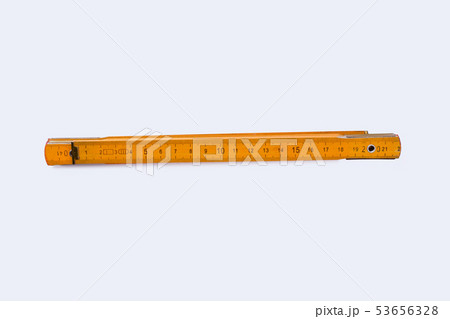 Yellow folding ruler isolated on white background. 53656328