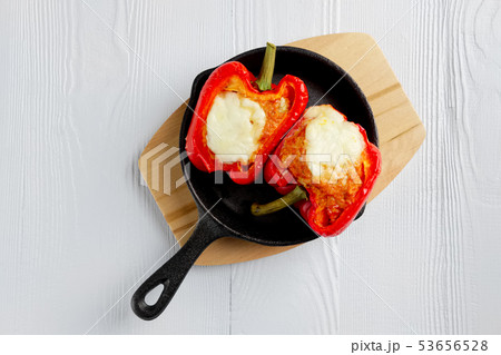 Bell pepper stuffed with meat with melted cheese 53656528