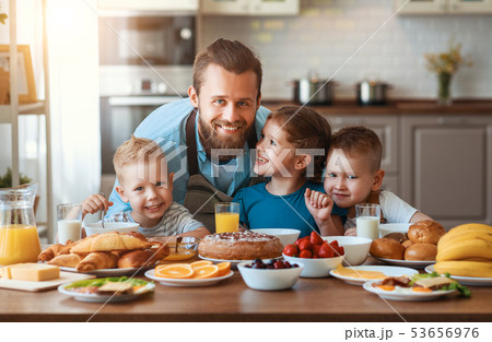 happy family father with children feeds his sons happy family father with children feeds his sons 53656976