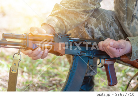 automatic machine gun in the hands of the military 53657710