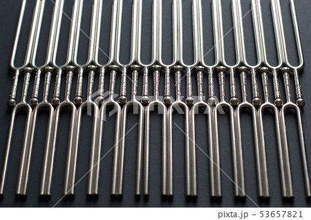 Tuning fork pattern on a black background Tuning fork pattern on a black background 53657821
