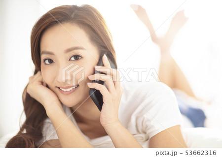 young smiling woman talking on phone 53662316