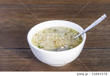 Boiled pork in white bowl on wooden table. 53665478