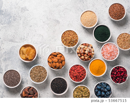 Various superfoods in bowl on gray background Various superfoods in bowl on gray background 53667515