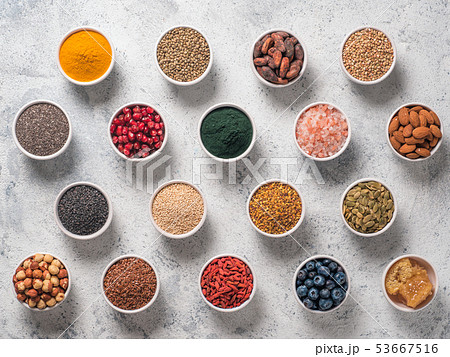 Various superfoods in bowl on gray background Various superfoods in bowl on gray background 53667516