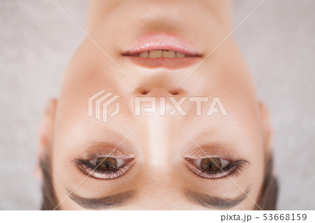 Eyelashes extensions. Fake Eyelashes. Eyelash Extension Procedure. Professional stylist lengthening 53668159