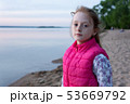 Beautiful pensive teen girl with freckles by sea at sunset 53669792