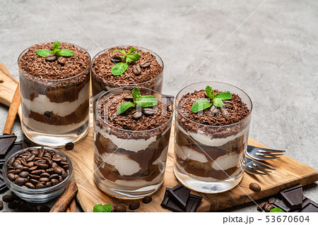 Classic tiramisu dessert in a glass on dark concrete background 53670604
