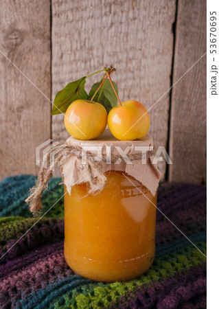 Full jar of apple jam on the wooden background. 53670695
