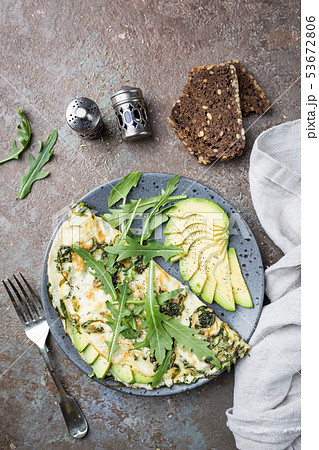 Omelette with avocado and arugula 53672806