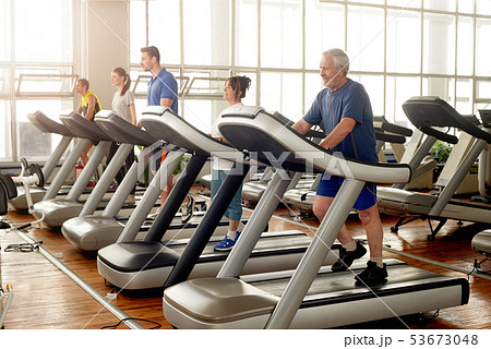 Group of people running on treadmills. Group of people running on treadmills. 53673048