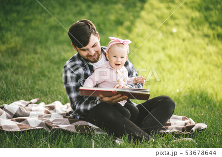 Father and his baby daugter playing in a park Father and his baby daugter playing in a park 53678644