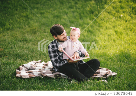 Father and his baby daugter playing in a park 53678645