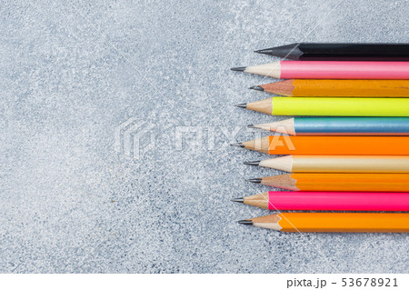 Bright colored pencils on the grey table. concept Bright colored pencils on the grey table. concept 53678921