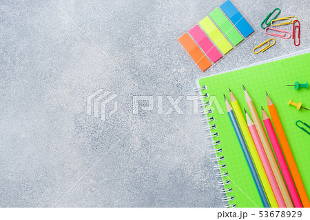 School supplies, notebooks pencils on grey 53678929