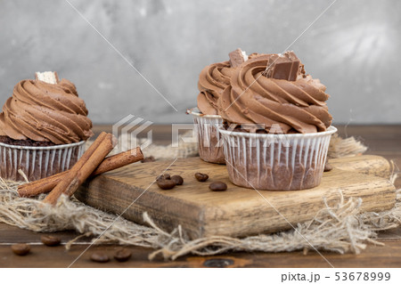 brown cupcakes with cocoa cream, cinnamon and 53678999