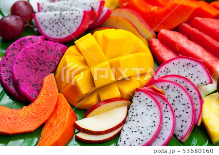 Tropical fruits assortment on green palm leaf. Close up. 53680160