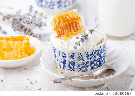 Ice cream with honey and lavender in bowls. White background. Ice cream with honey and lavender in bowls. White background. 53680167