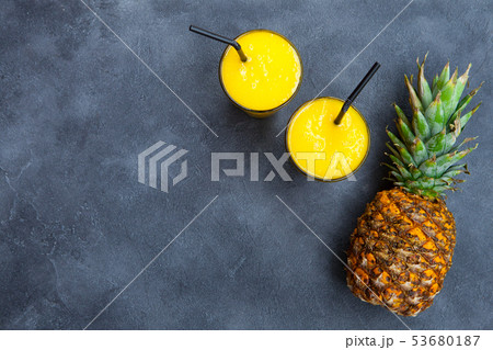 Pineapple with tropical fruit juice, smoothie on dark background. Copy space. Top view. 53680187