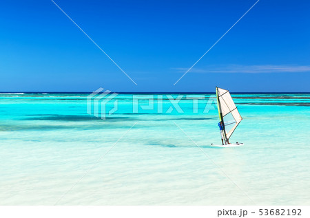 Windsurfer in the sea with a blue sky background. 53682192