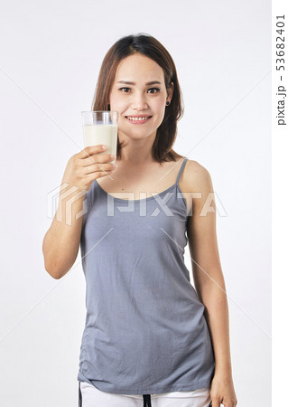Woman holding a glass of milk 53682401