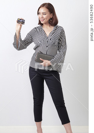 Asian woman holding credit card Asian woman holding credit card 53682490