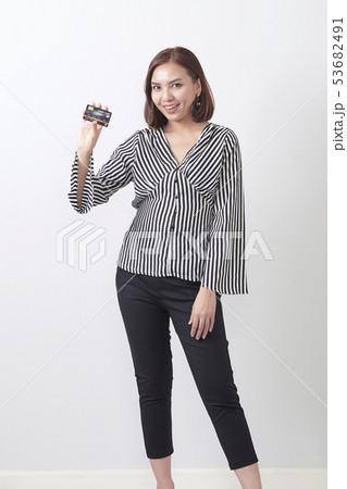 Asian woman holding credit card Asian woman holding credit card 53682491