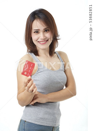 Young smiling asian woman presenting credit card Young smiling asian woman presenting credit card 53682851