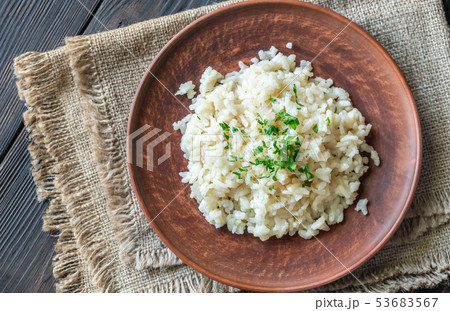 Portion of risotto on the wooden table 53683567