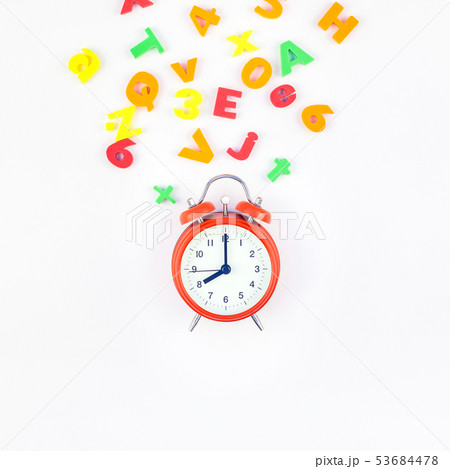 Alarm clock and multicolor alphabet 53684478