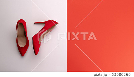 A studio shot of pair of high heel shoes on color background. Flat lay. A studio shot of pair of high heel shoes on color background. Flat lay. 53686266