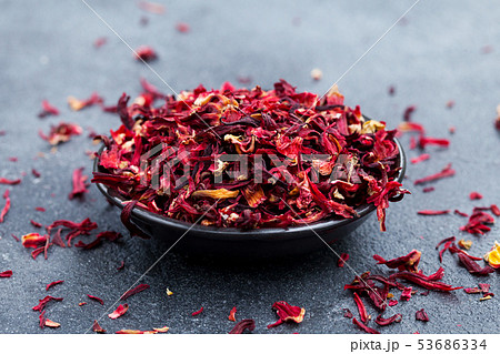Hibiscus tea in black bowl. Slate background. Copy space. Hibiscus tea in black bowl. Slate background. Copy space. 53686334