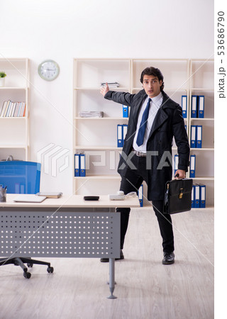 Young male employee in the office in time management concept Young male employee in the office in time management concept 53686790