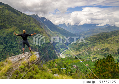 Man standing on hill top in Himalayas Man standing on hill top in Himalayas 53687125