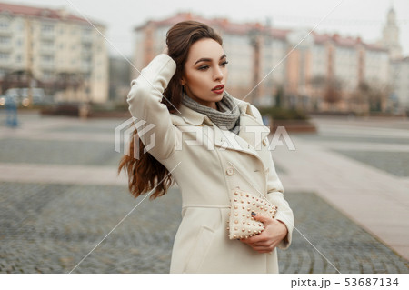 Beautiful fashionable girl in a trendy coat Beautiful fashionable girl in a trendy coat 53687134