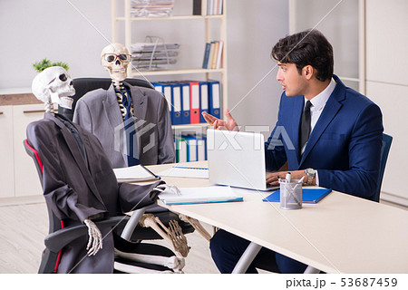 Funny business meeting with boss and skeletons 53687459