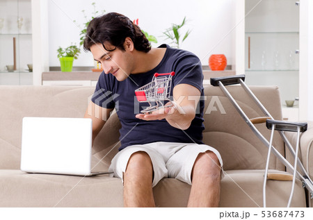 Leg injured young man suffering at home  53687473