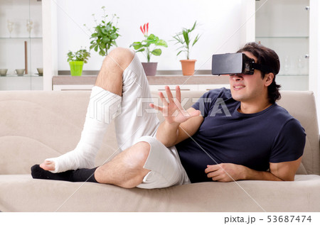 Leg injured young man suffering at home Leg injured young man suffering at home 53687474