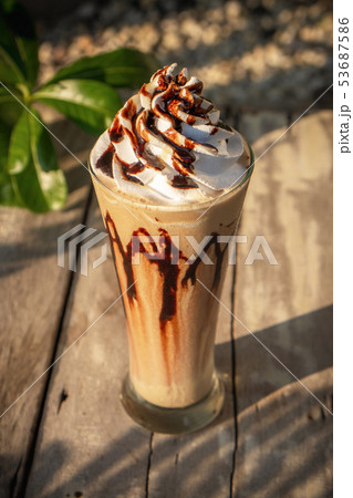 Coffee frappe with whipped cream on old wooden Coffee frappe with whipped cream on old wooden 53687586