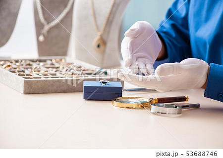 Young jeweler working in his workshop Young jeweler working in his workshop 53688746