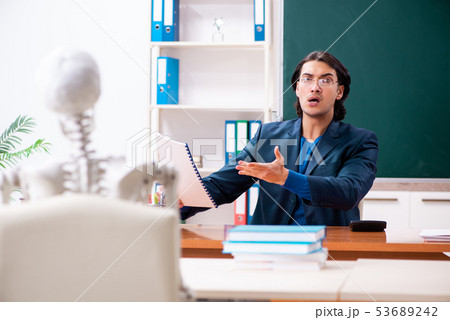 Male teacher and skeleton student in the classroom  53689242