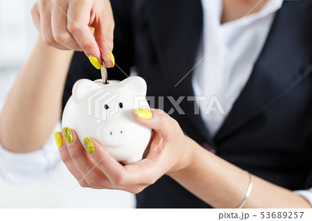 Female hand putting pin money coins Female hand putting pin money coins 53689257