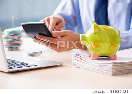 Young male employee in budget planning concept Young male employee in budget planning concept 53689481