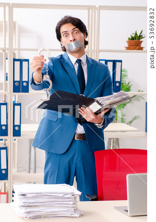 Young male employee with tape on the mouth  53692832