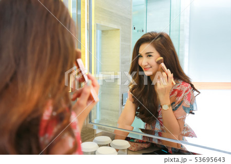 Woman getting ready for work doing morning makeup 53695643